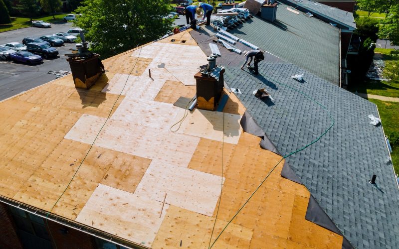 Roof repairs old roof replacement with new shingles of an apartment building